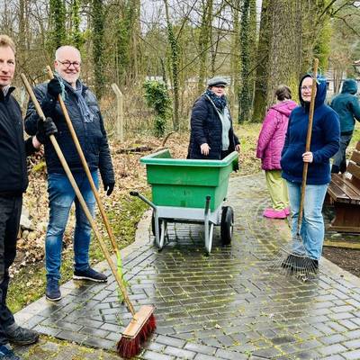 Eine Gruppe von personen posieren für ein Foto während der Gehwegreinigung